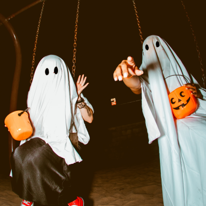 People in Ghost Costume on Swings